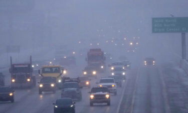 Cars drive north on I-15 after an overnight storm in Lehi