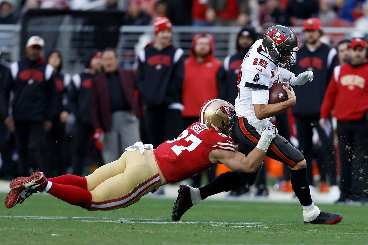 <i>Jed Jacobsohn/AP</i><br/>Tampa Bay Buccaneers quarterback Tom Brady runs against San Francisco 49ers defensive end Nick Bosa during the second half of their game.