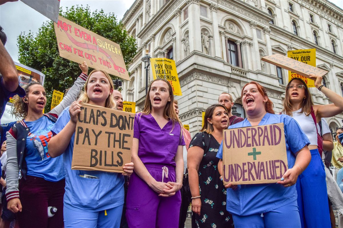 <i>Vuk Valcic/SOPA Images/Sipa USA/AP</i><br/>Protesters hold placards demanding fair pay for healthcare workers during a demonstration outside Downing Street.