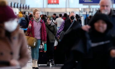 Travelers walk through Terminal 3 at O'Hare International Airport in Chicago.