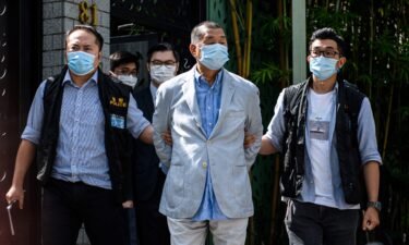 Police lead Hong kong pro-democracy media mogul Jimmy Lai away from his home after he was arrested under the new national security law in Hong kong on August 10