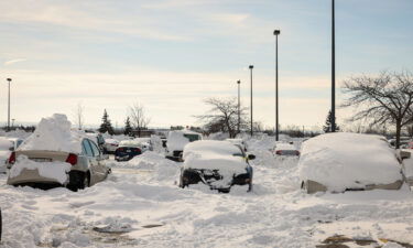 Abandoned cars are piled in snow after being towed to a parking lot following a winter storm in Buffalo