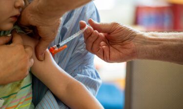 A young child receives a Moderna Covid-19 vaccine in Needham