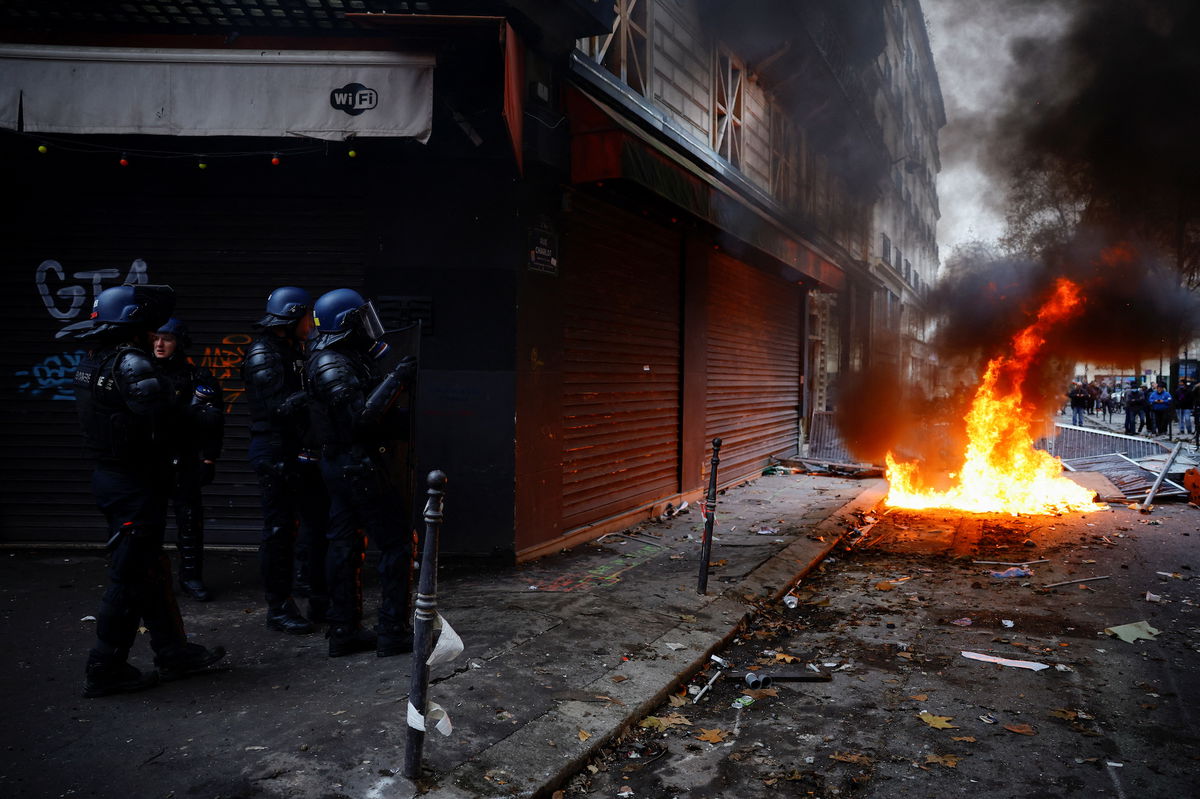 <i>Sarah Meyssonnier/Reuters</i><br/>Gendarmerie officers stand guard as members of the Kurdish community demonstrate in Paris on December 24.