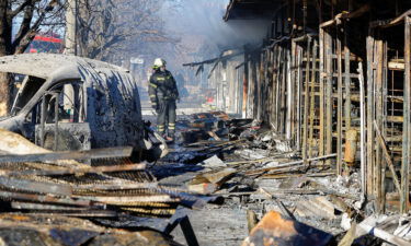 A firefighter stands in front of burned market stalls hit by shelling in Donetsk on December 6.