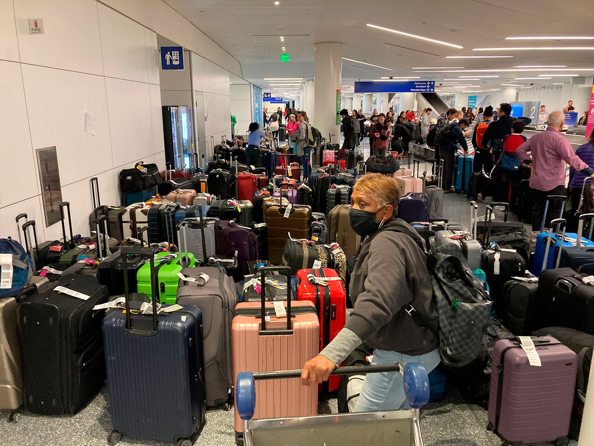 <i>Eugene Garcia/AP</i><br/>Baggage waits to be claimed after canceled flights at the Southwest Airlines terminal at Los Angeles International Airport on Monday