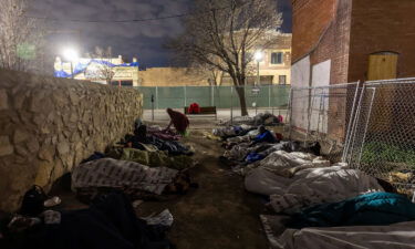 Immigrants sleep in the cold outside a bus station on December 18