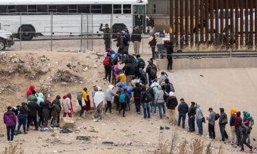 Immigrants seeking asylum turn themselves in to US Border Patrol agents after wading across the Rio Grande to El Paso