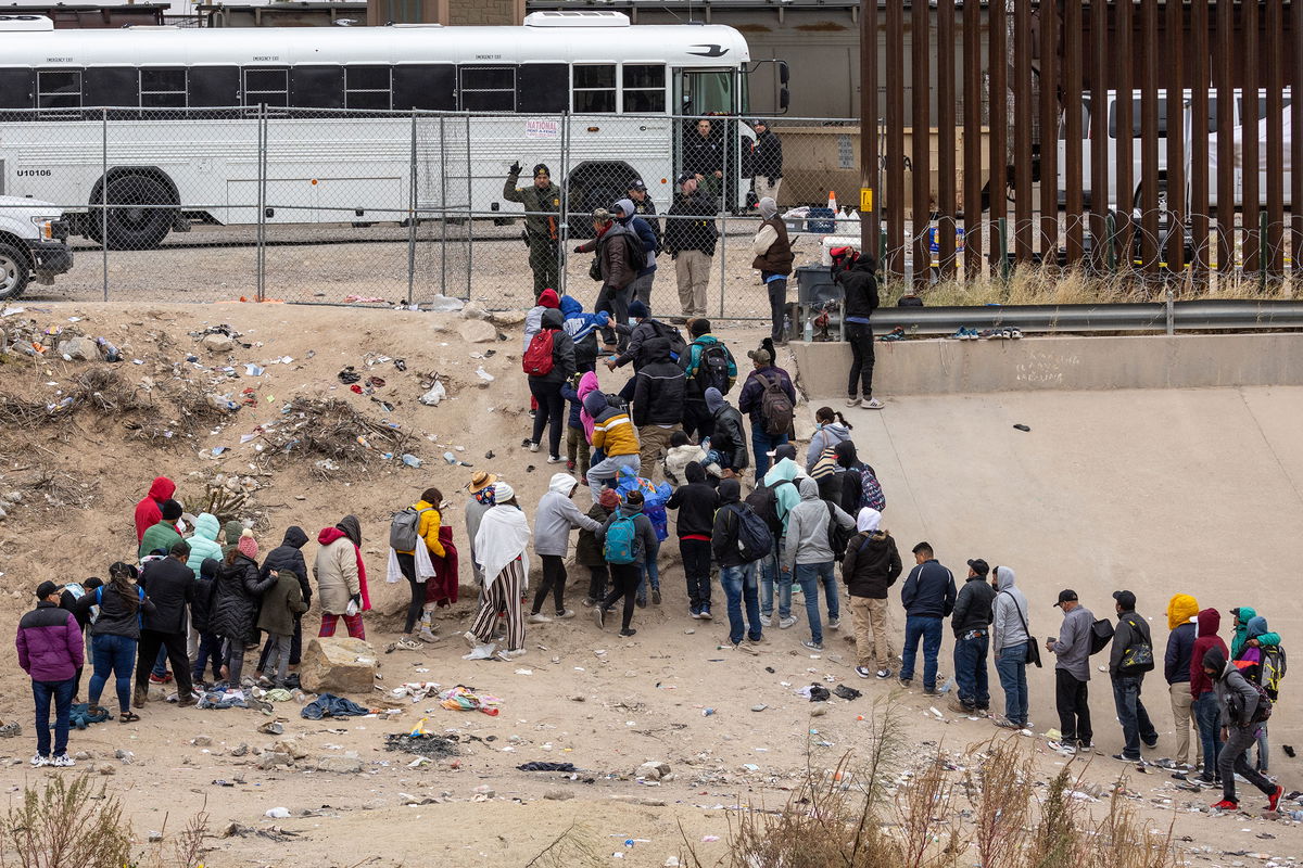 <i>John Moore/Getty Images</i><br/>Immigrants seeking asylum turn themselves in to US Border Patrol agents after wading across the Rio Grande to El Paso