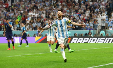 Lionel Messi celebrates after scoring Argentina's first goal from the penalty spot.