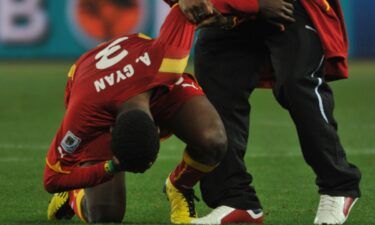 Asamoah Gyan (left) is consoled following the penalty shootout defeat in 2010.