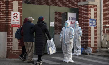 Medical staff wait to assist a patient at a fever clinic treating Covid-19 patients in Beijing on December 21.