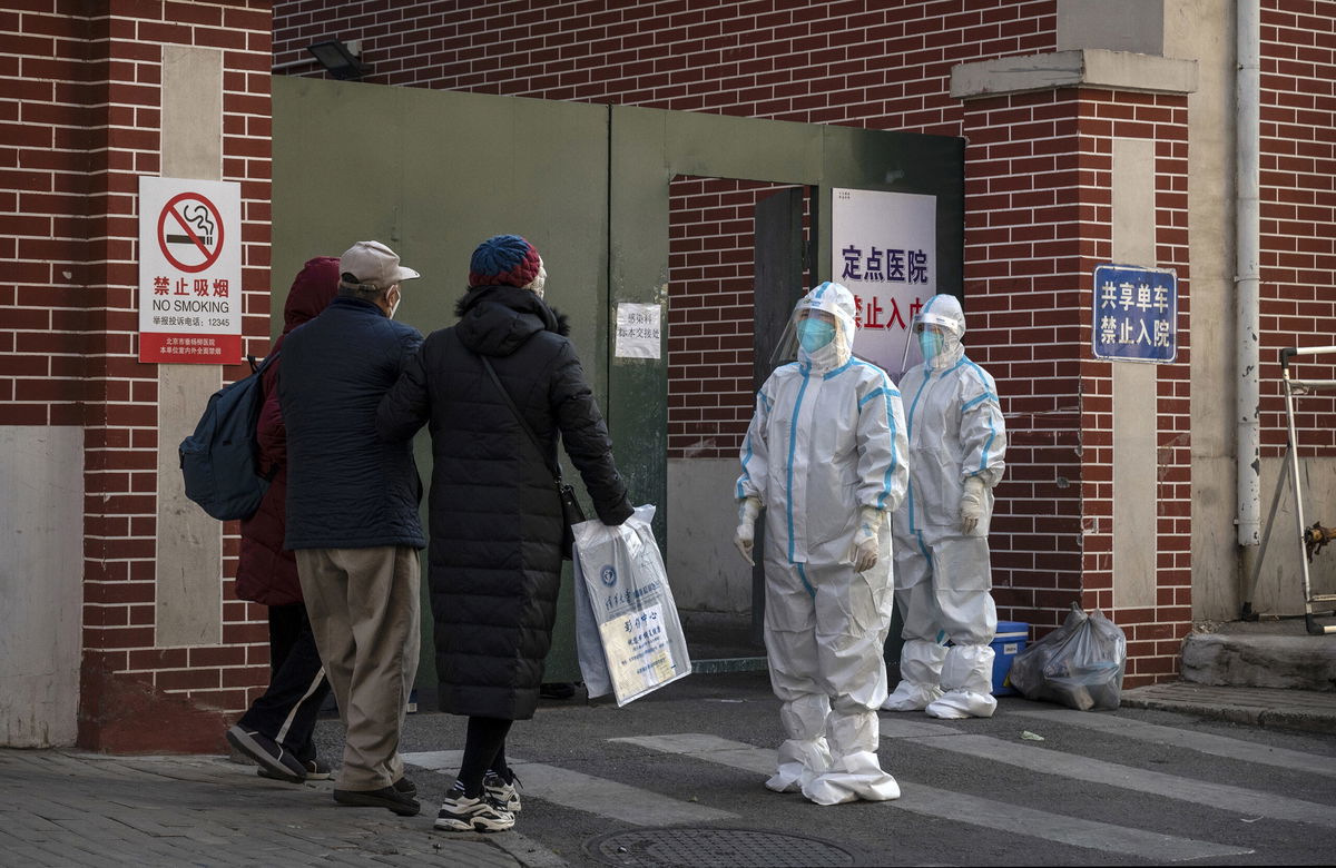 <i>Kevin Frayer/Getty Images</i><br/>Medical staff wait to assist a patient at a fever clinic treating Covid-19 patients in Beijing on December 21.