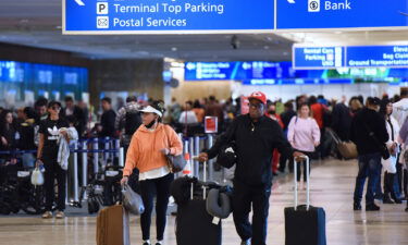 Travelers make their way through Orlando International Airport on Wednesday