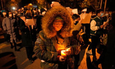 Protesters march in Beijing on November 27. Several cities have taken steps to ease some Covid-19 restrictions.