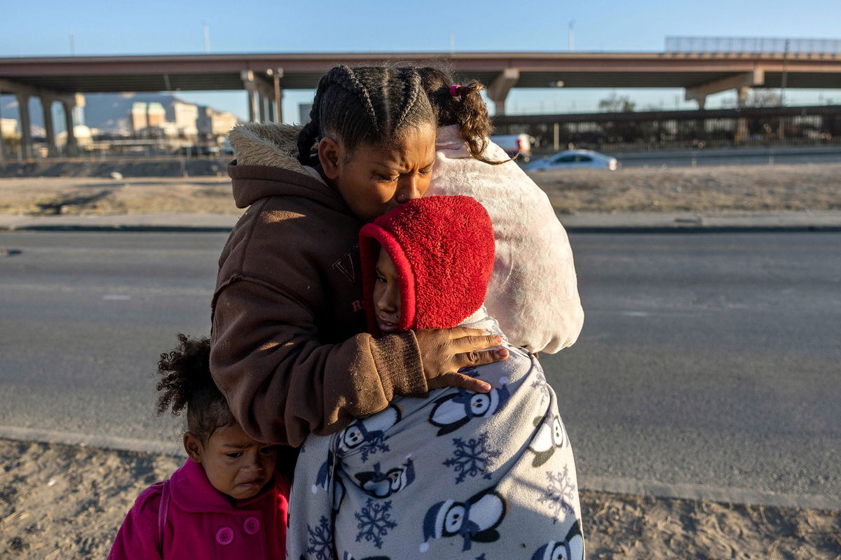 <i>John Moore/Getty Images</i><br/>Venezuelan immigrant Yaneisi Martinez weeps while embracing her three children after Texas National Guard troops and state police blocked a popular border crossing area on December 20