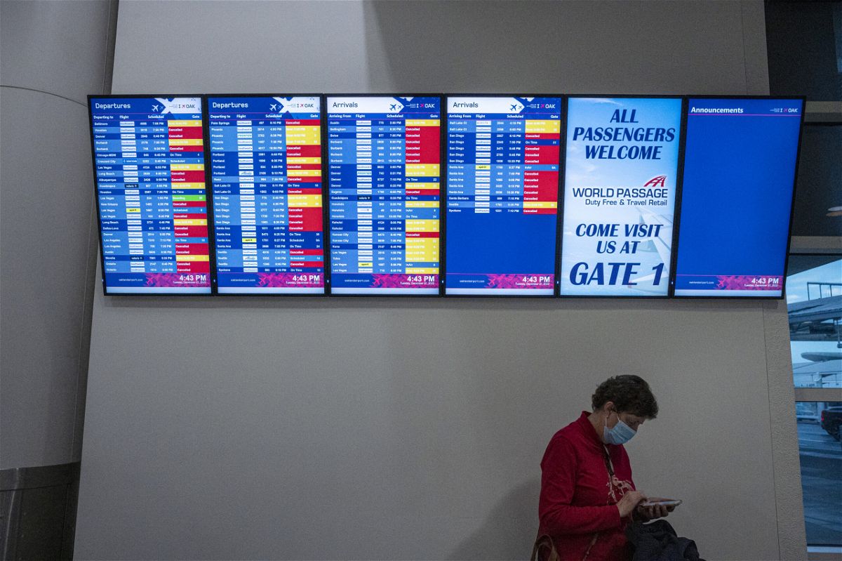 <i>Bloomberg/Bloomberg/Bloomberg/Getty Images</i><br/>Cancelled Southwest Airlines flights are displayed on an information board at California's Oakland International Airport on Tuesday.