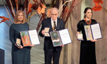 Representatives of the 2022 Nobel Peace Prize laureates collect the awards at Oslo City Hall.