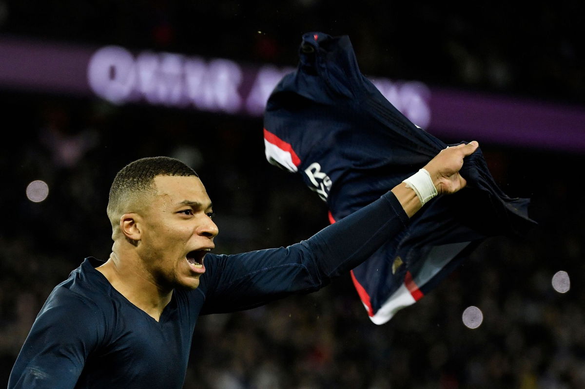 <i>JULIEN DE ROSA/AFP/AFP via Getty Images</i><br/>Kylian Mbappé celebrates after scoring a last-minute penalty for PSG in his first match since the World Cup final.