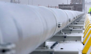 A worker walks past gas pipes in Wilhelmshaven