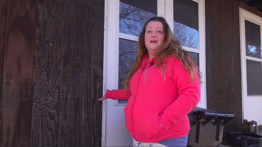 <i>KMOV</i><br/>Tina Abbacchi shows the area where an arrow hit her home.