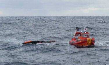 A South Korea Coast Guard vessel searches for crew from a capsized ship in waters between South Korea and Japan on January 25