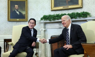 US President Joe Biden and Japanese Prime Minister Fumio Kishida shake hands during a meeting in the Oval Office at the White House in Washington