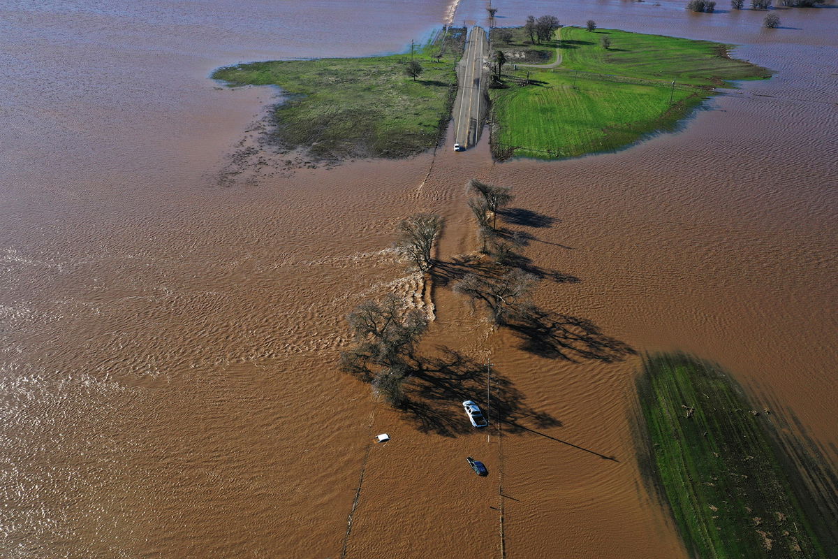 <i>Hector Amezcua/AP</i><br/>Three vehicles are submerged on Dillard Road west of Highway 99 in south Sacramento County in Wilton