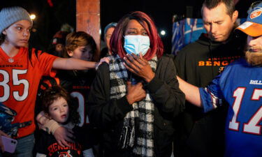 Fans hold a candlelight prayer service for Buffalo Bills safety Damar Hamlin at the UC Medical Center in Cincinnati