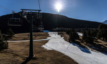 Dry ground surrounds a narrowed ski run at La Molina ski resort in Girona