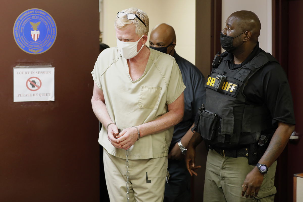 Lawyer Alex Murdaugh walks into his bond hearing, Thursday, Sept. 16, 2021, in Varnville, S.C. Murdaugh surrendered Thursday to face insurance fraud and other charges after state police said he arranged to have himself shot in the head so that his son would get a $10 million life insurance payout. (AP Photo/Mic Smith)