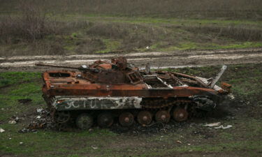 Destroyed Russian armored car standing by the railway line seen from the window of an evacuation train from Kherson to Khmelnytskyi