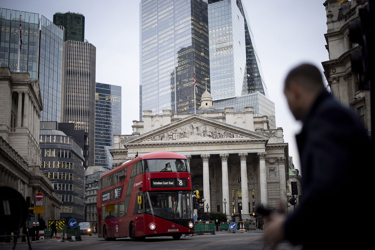 <i>Tolga Akmen/EPA-EFE/Shutterstock</i><br/>A person crosses the street outside the Bank of England in London on January 23.