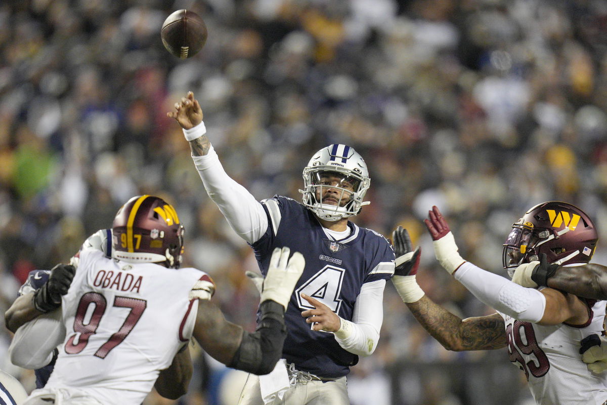 <i>Jess Rapfogel/Getty Images</i><br/>Dak Prescott #4 throws the ball as Efe Obada #97 of the Washington Commanders and Chase Young #99 defend during the first half at FedExField.