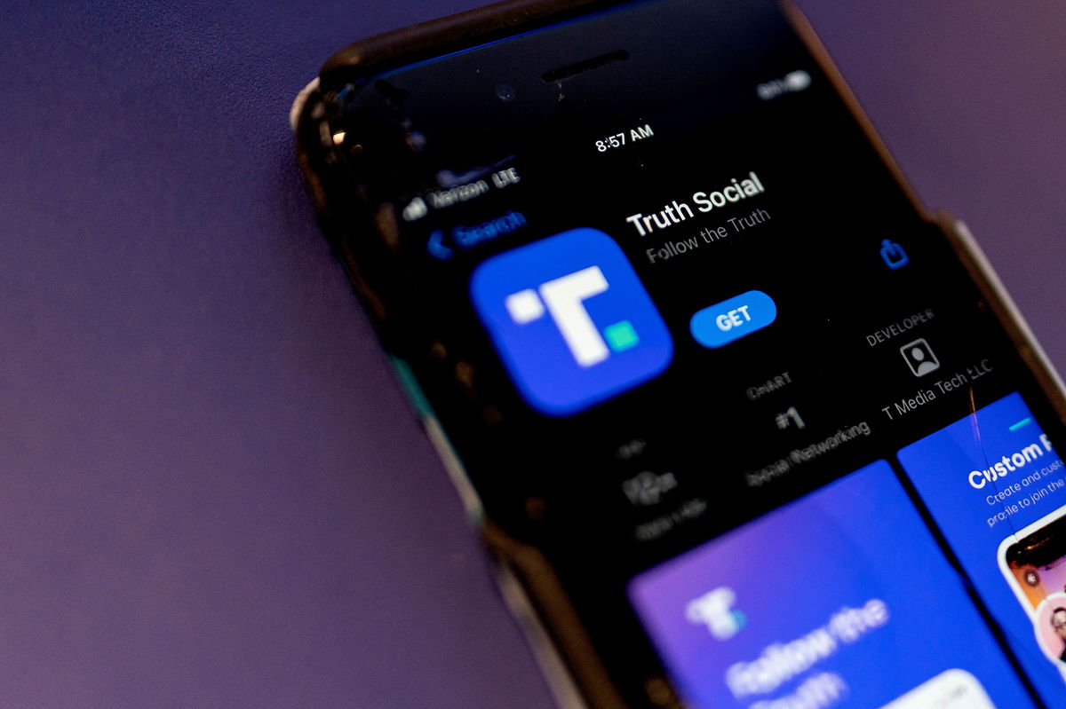 <i>Stefani Reynolds/AFP/Getty Images</i><br/>A phone screen displays the Truth Social app in Washington