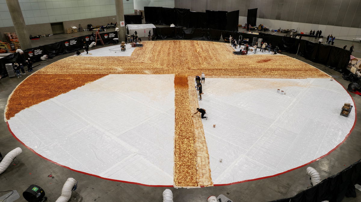 Cooks work inside the Los Angels Convention center as Pizza Hut attempts to create the World's largest pizza of 14,101 square feet in Los Angeles, California, U.S., January 18, 2023.   REUTERS/Mike Blake