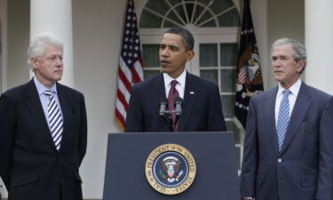 President Barack Obama (center) speaks as former Presidents Bill Clinton (left) and George W. Bush (right) listen in the Rose Garden at the White House in January of 2010.