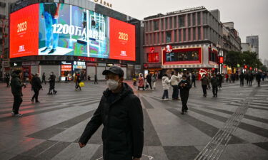 People walk on a street in Wuhan