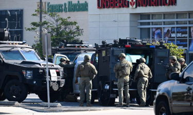 Law enforcement personnel open the door of a van in Torrance Sunday.