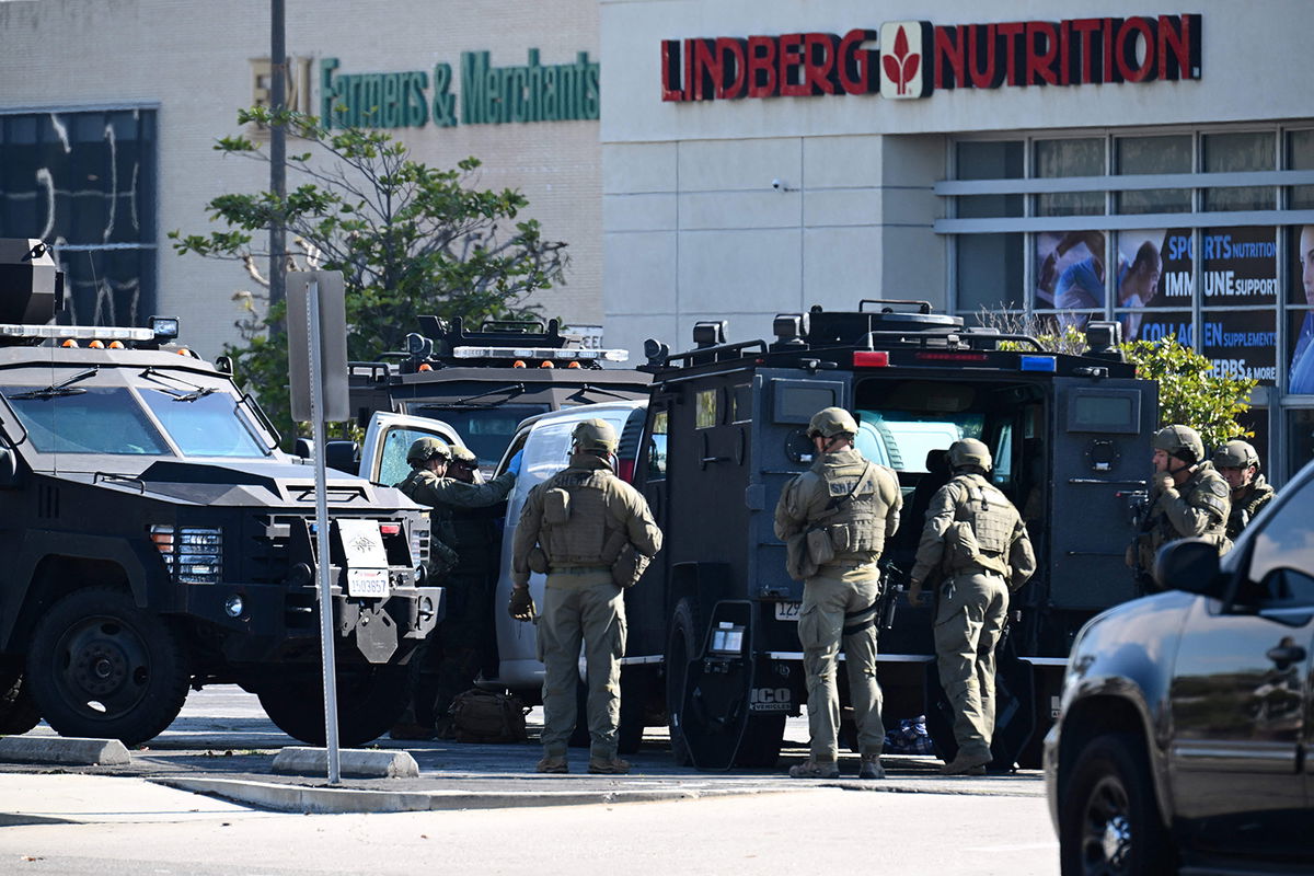 <i>Robyn Beck/AFP/Getty Images</i><br/>Law enforcement personnel open the door of a van in Torrance Sunday.