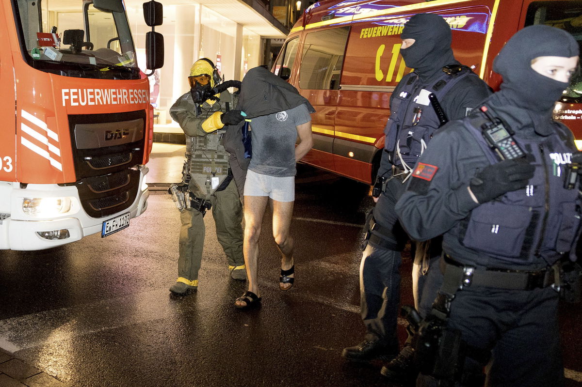 <i>Karsten Wickern/picture alliance/dpa/AP</i><br/>German police detain the suspect in Castrop-Rauxel