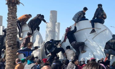 Soccer fans attempt to enter the Basra International Stadium to watch the final match of the 25th Arabian Gulf Cup between Iraq and Oman