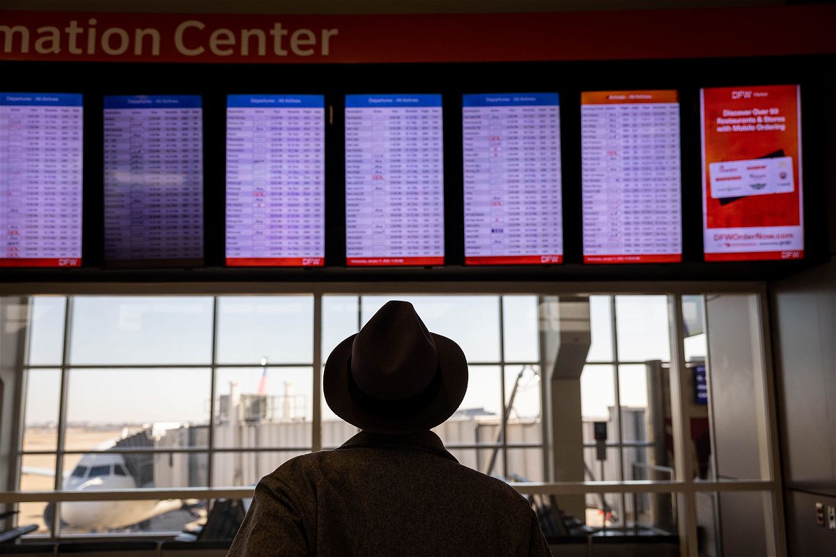 <i>John Moore/Getty Images</i><br/>Passengers pass through Dallas-Fort Worth International Airport on January 11.