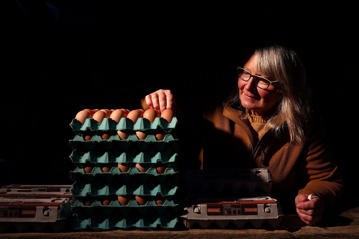 <i>Fiona Goodall/Getty Images</i><br/>An egg vendor setting up her stall before dawn at a farmers market in 2020 in Auckland. New Zealand is currently undergoing a major egg shortage