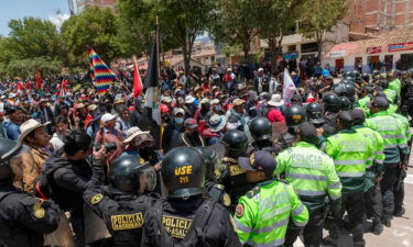 Demonstrators confront police forces as they block the way to Alejandro Velasco Astete International Airport.