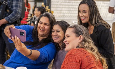 Monica De La Cruz takes a selfie with supporters in McAllen