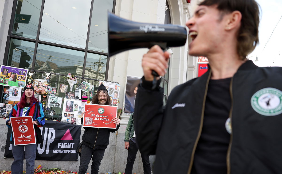 <i>Justin Sullivan/Getty Images</i><br/>Striking Starbucks workers hold signs and chant outside of a Starbucks coffee shop during a national strike on November 17