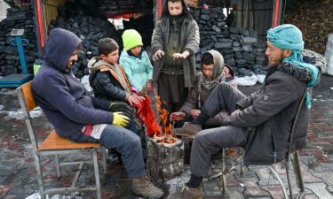 Afghans gather around a bonfire after snowfall in Kabul on January 23.