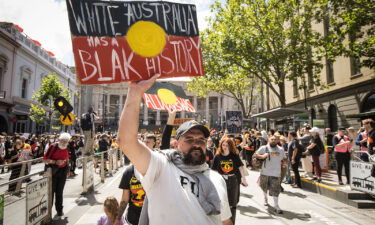 People march down Bourke street during the Invasion Day rally on January 26 in Melbourne