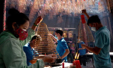 People pray over incense at Thien Hau Pagoda for the Tet Lunar New Year on January 24 in Ho Chi Minh City